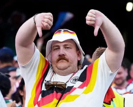 A Germany fan makes a thumbs-down sign