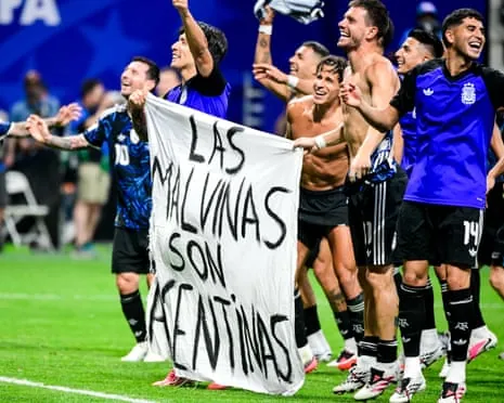 Argentina players hold a banner which says: ‘Las Malvinas son Argentinas’ – the Falkland Islands are Argentinian